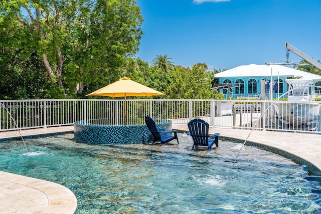 view of swimming pool with a patio and pool water feature