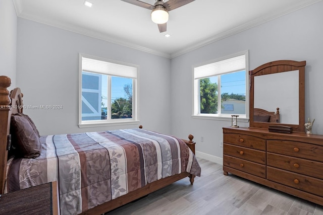 bedroom featuring ceiling fan, ornamental molding, and light hardwood / wood-style flooring