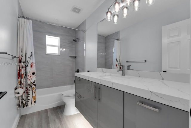 full bathroom featuring shower / bath combo with shower curtain, vanity, toilet, and hardwood / wood-style floors