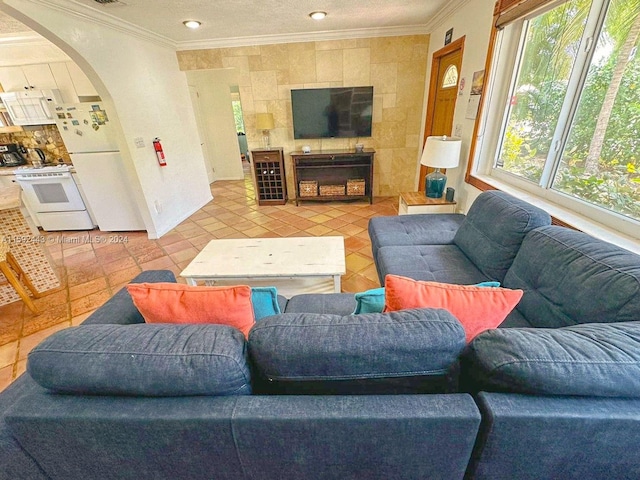 tiled living room with tile walls and crown molding