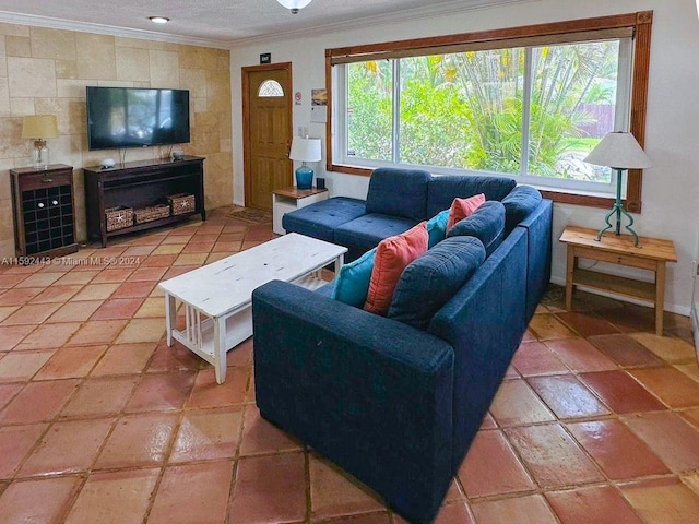 living room with tile floors, plenty of natural light, and ornamental molding