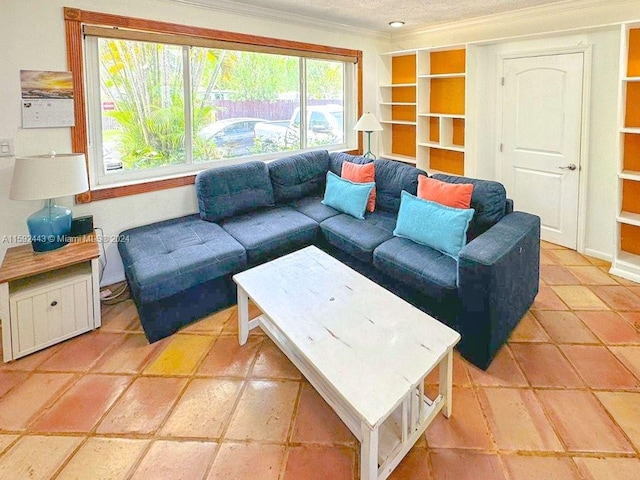 living room featuring ornamental molding, built in shelves, and light tile floors