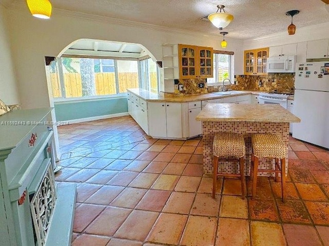 kitchen featuring white cabinetry, white appliances, backsplash, and light tile flooring