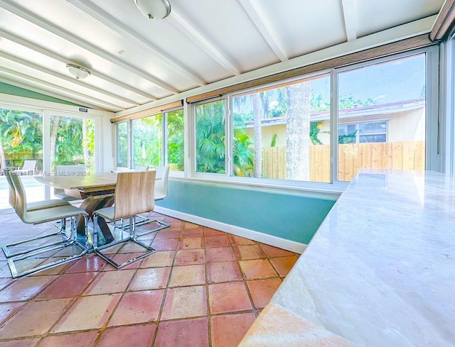 sunroom with lofted ceiling with beams