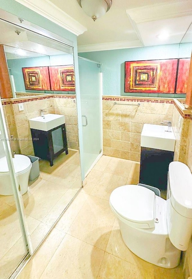 bathroom featuring tile walls, toilet, tile floors, ornamental molding, and vanity