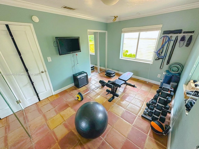 workout area with tile floors and crown molding