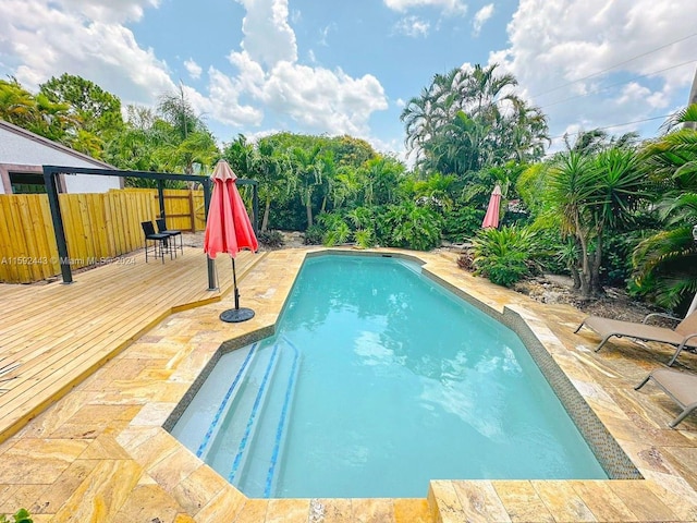 view of swimming pool with a wooden deck