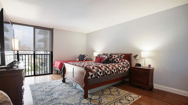 bedroom with hardwood / wood-style flooring and a textured ceiling