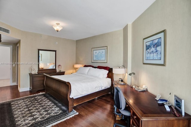 bedroom with dark hardwood / wood-style flooring