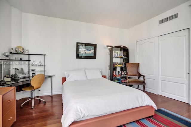 bedroom featuring a closet and dark hardwood / wood-style flooring