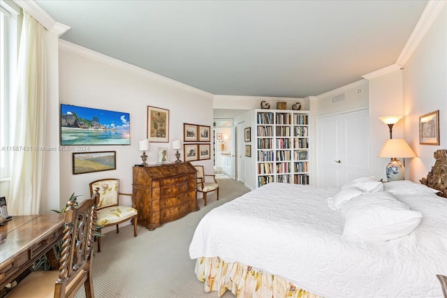 bedroom with ornamental molding, carpet flooring, and a closet