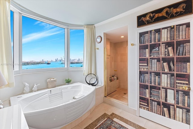 bathroom featuring tile flooring, ornamental molding, separate shower and tub, and a water view