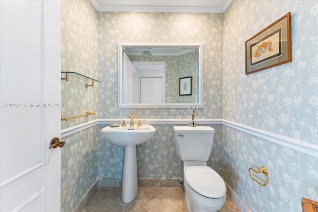 bathroom featuring tile flooring, ornamental molding, and toilet