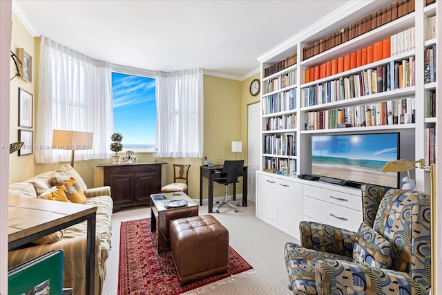 sitting room with ornamental molding, carpet, and built in shelves