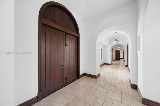 foyer with a towering ceiling and light tile floors