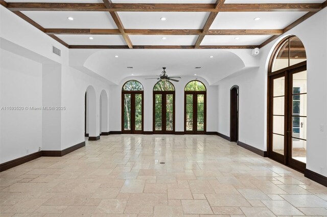 tiled empty room featuring beam ceiling, french doors, coffered ceiling, and ceiling fan