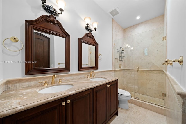 bathroom with dual vanity, tile flooring, an enclosed shower, and toilet