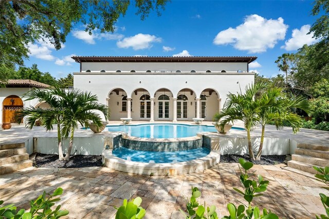 view of swimming pool with a hot tub and a patio area