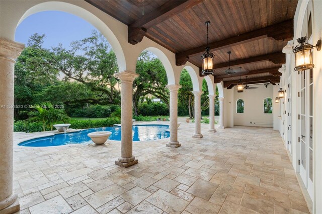 view of pool with ceiling fan and a patio