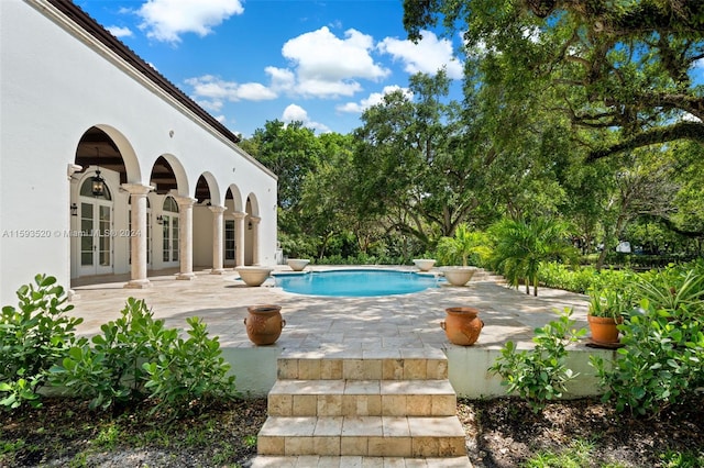 view of swimming pool with a patio area and french doors