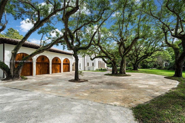 view of property exterior featuring a garage and a yard