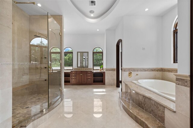 bathroom featuring tile flooring, a healthy amount of sunlight, vanity, and independent shower and bath