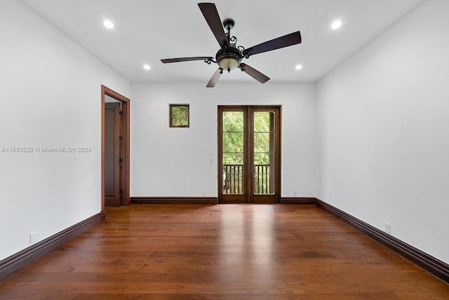 empty room with french doors, dark wood-type flooring, and ceiling fan