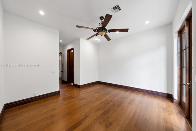 empty room featuring wood-type flooring and ceiling fan