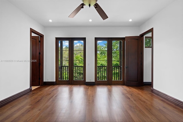 unfurnished room with dark hardwood / wood-style floors and ceiling fan