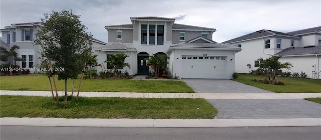 view of front of house featuring a garage and a front yard