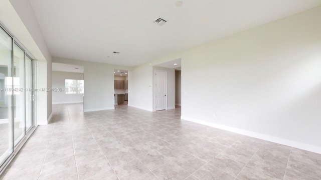 spare room featuring light tile flooring