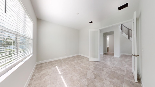 unfurnished room with light tile flooring