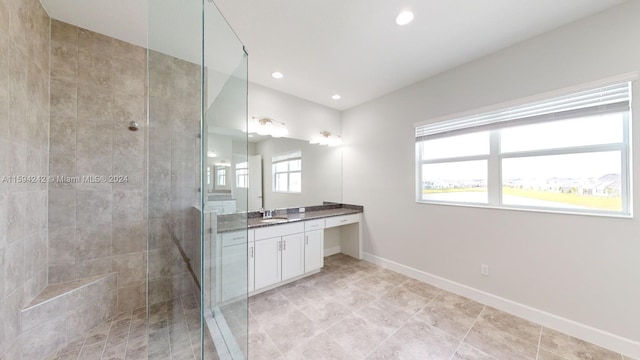 bathroom featuring tile floors, vanity with extensive cabinet space, and an enclosed shower