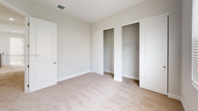 unfurnished bedroom with light carpet