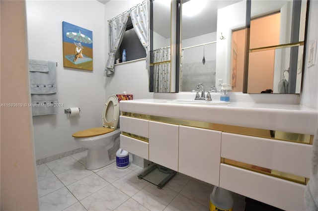 bathroom featuring tile patterned floors, vanity, and toilet