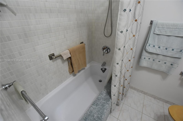 bathroom with shower / bath combo with shower curtain, tile patterned floors, and toilet