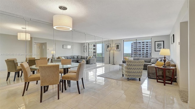 tiled dining space featuring a textured ceiling