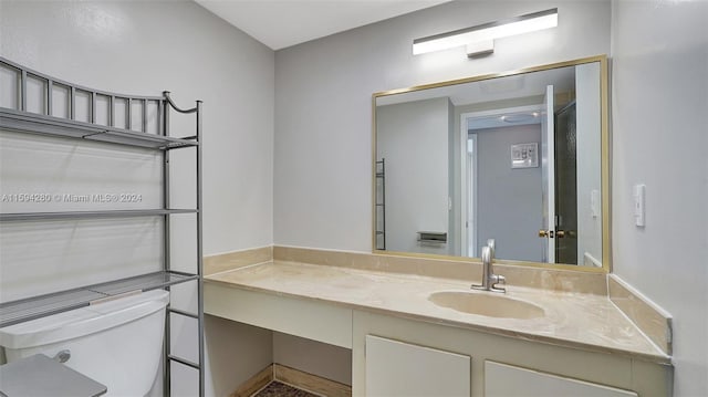 bathroom featuring toilet and large vanity