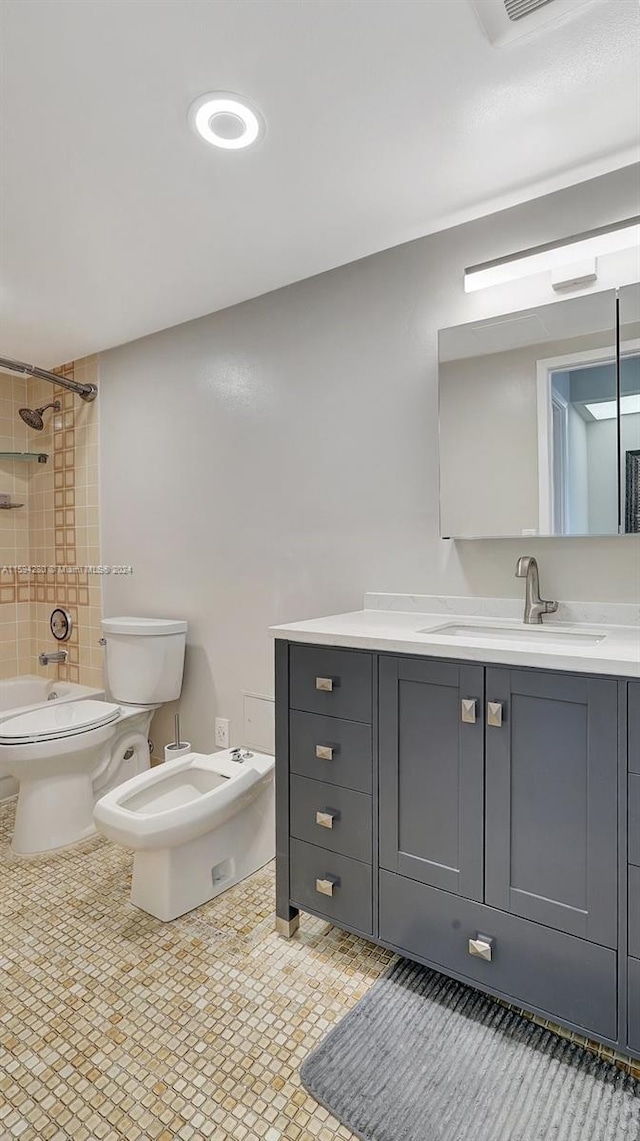 full bathroom with tile flooring, a bidet, tiled shower / bath combo, toilet, and vanity