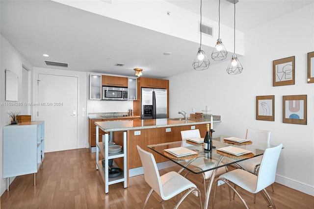 dining space with sink and hardwood / wood-style flooring