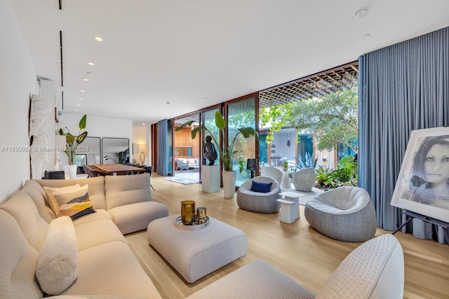 living room with floor to ceiling windows and wood-type flooring