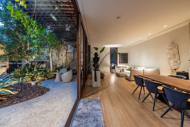 interior space featuring brick wall and light hardwood / wood-style floors