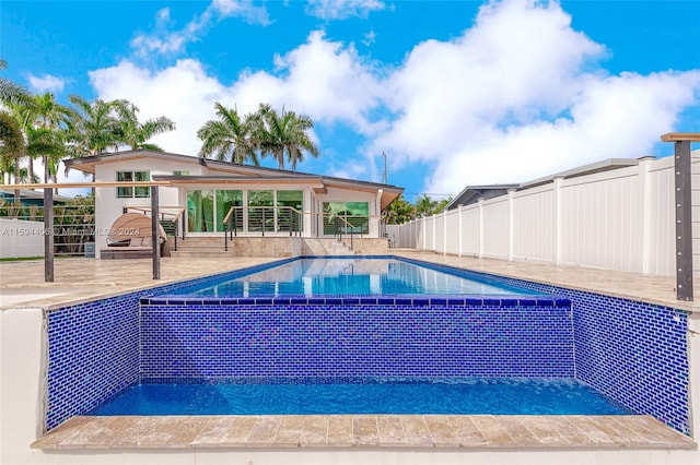 view of swimming pool with a patio area