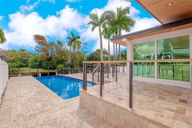 view of swimming pool with a patio