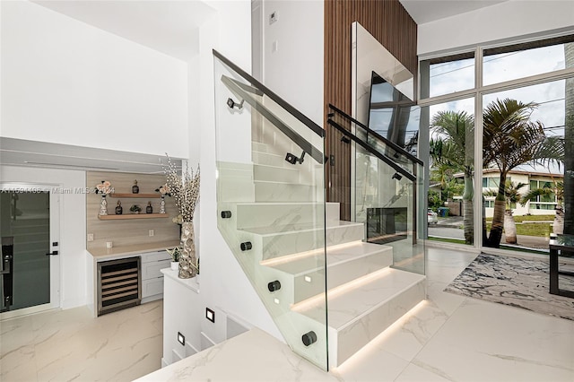 stairs with beverage cooler and light tile flooring