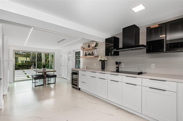 kitchen featuring wall chimney range hood, light tile flooring, beverage cooler, black electric stovetop, and tasteful backsplash