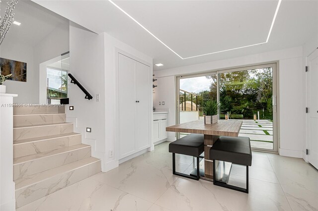 dining space with light tile floors