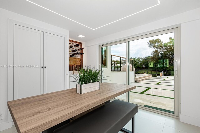 dining space featuring plenty of natural light and light tile floors