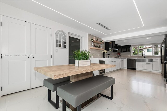 tiled dining area featuring wine cooler and sink