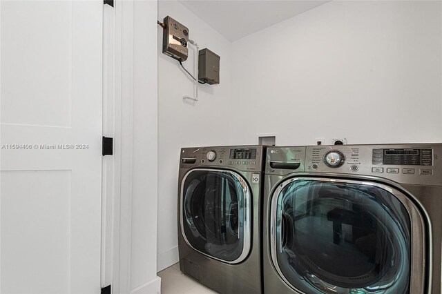 laundry area with washer and clothes dryer, light tile floors, and hookup for a washing machine